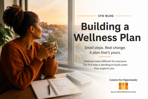 A person pausing with a warm drink by a window, beginning to build a wellness plan.